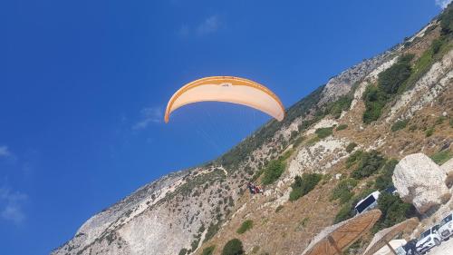 a person flying a parachute over a mountain at BlueTel Lixouri in Lixouri