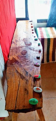 a wooden table with buttons on it next to a couch at Riverside at Aninuan Accommodation and Food in Puerto Galera