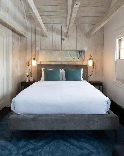 a bedroom with a large white bed with two lamps at The Water Street Inn in Kittery
