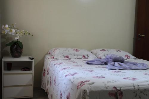 a bed with a blanket and a stuffed animal on it at RECANTO JK in Taguatinga