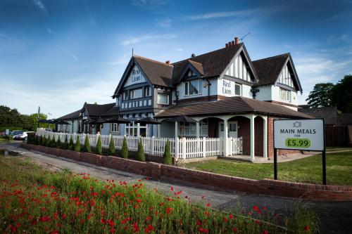 a large house with a sign in front of it at The Red Lion Inn by Chef & Brewer Collection in Todwick