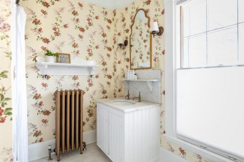 a bathroom with a sink and a mirror at The Water Street Inn in Kittery