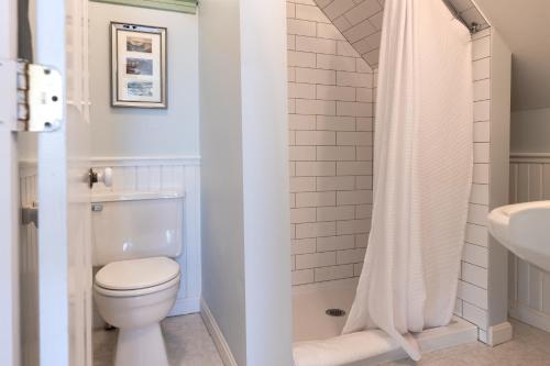 a bathroom with a toilet and a sink at The Water Street Inn in Kittery