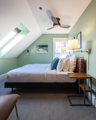 a bedroom with a bed and a ceiling fan at The Water Street Inn in Kittery