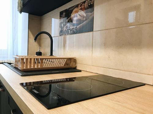 a kitchen with a sink and a counter top at Over the City in Oradea