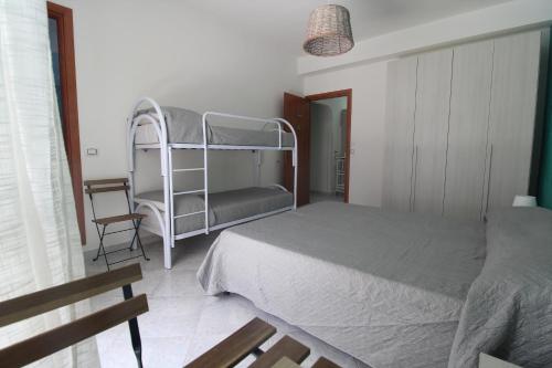a bedroom with a bunk bed and a chair at sognandocasab&b tortora in Praia a Mare