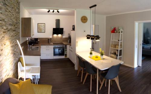 a kitchen and living room with a table and chairs at Urlaub in Andreasberg in Sankt Andreasberg