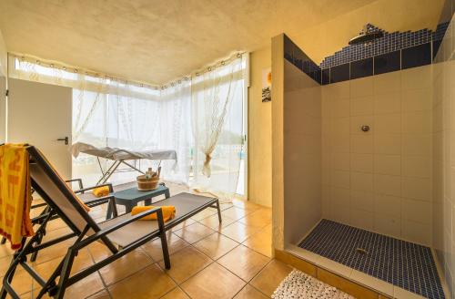 a bathroom with a shower with a chair and a table at Apartment La Gomera II in San Juan de la Rambla