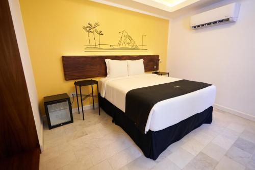 a bedroom with a large bed in a room at The Xperience by g in Mazatlán