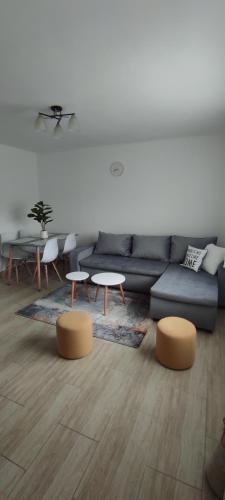 a living room with a couch and a table and chairs at Vikend house in Ljig