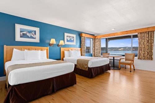 a hotel room with two beds and a table at Skylark Shores Resort in Lakeport