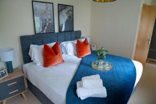 um quarto com uma cama grande e almofadas vermelhas em Moda Stays - Bell Barn House em Birmingham