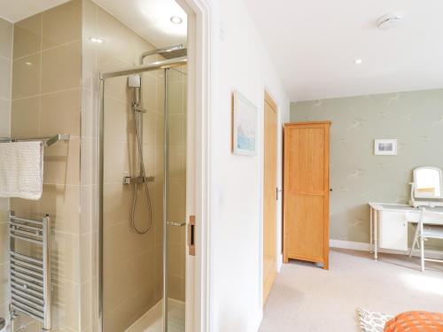 a bathroom with a shower with a glass door at Kinsale in Broadstairs