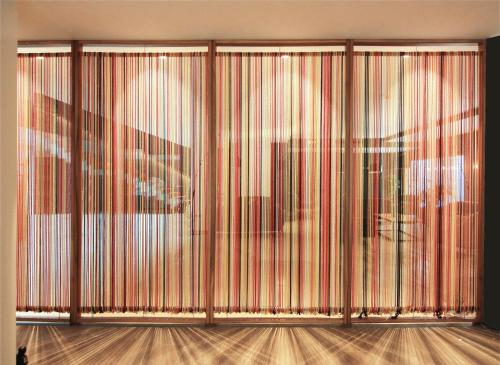 a room with a wall of sliding glass doors at Hotel Raval de la Mar in Vila-seca