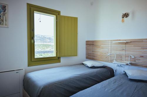 Ένα ή περισσότερα κρεβάτια σε δωμάτιο στο Abelonas Houses