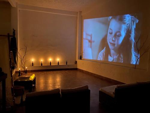 ein Wohnzimmer mit einem großen Bildschirm mit Kerzen in der Unterkunft Hotel Boutique Calderon in Huasca de Ocampo