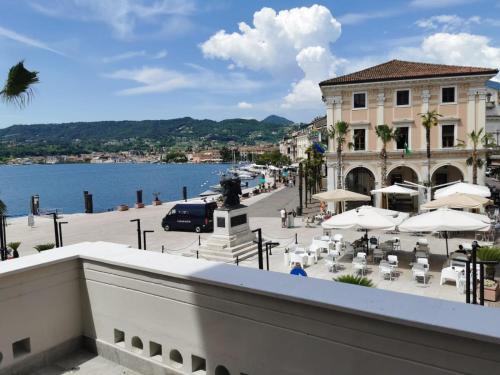 a view from a balcony of a building with tables and umbrellas at DIMORE DEL CENTRO - Domus Aurea in Salò