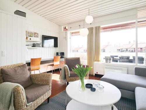 a living room with chairs and a table and a couch at 6 person holiday home on a holiday park in Sæby in Sæby