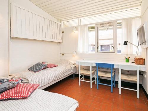 a room with two beds and a table in it at 6 person holiday home on a holiday park in Sæby in Sæby