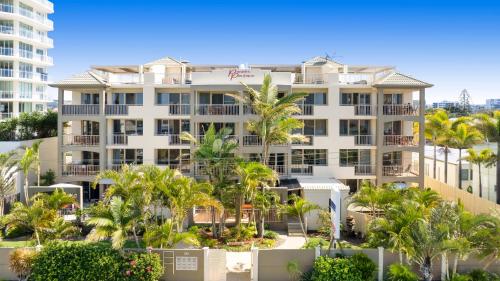 a large white building with palm trees in front of it at Paradis Pacifique in Maroochydore