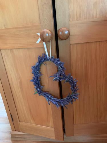 a wreath on the door of a wooden cabinet at Quail Farm, Colonial charm in Nelson