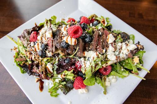 a salad on a white plate on a table at Swinomish Casino & Lodge in Anacortes