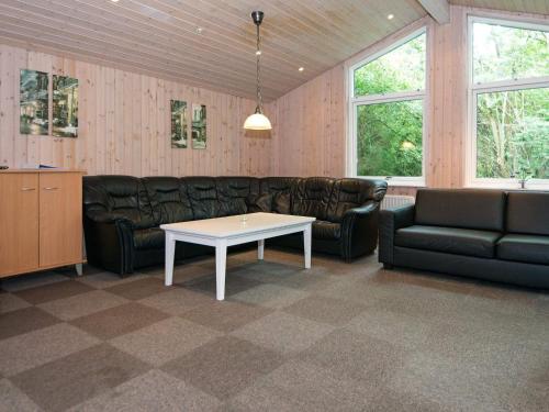 a living room with a couch and a table at 20 person holiday home in Herning in Herning