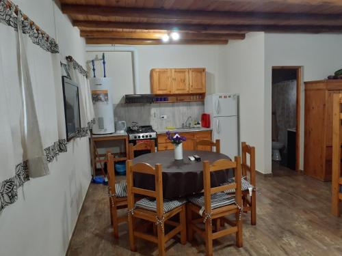 a kitchen with a table and chairs and a refrigerator at Alquiler zona centro in Villa Gesell