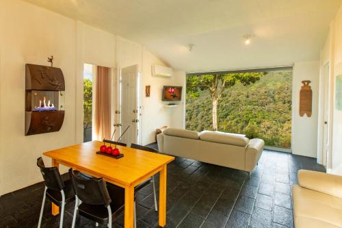 a living room with a table and a couch at Dantica Cloud Forest Lodge in San Gerardo de Dota