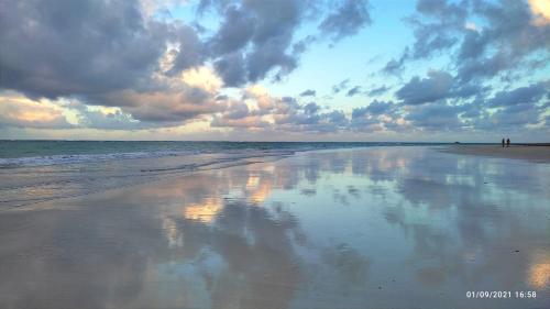 a view of a beach with a cloudy sky at Pousada Flor de Lótus Suites Carneiros in Tamandaré