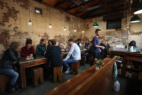 a group of people sitting at tables in a bar at Wagga Apartments #4 in Wagga Wagga