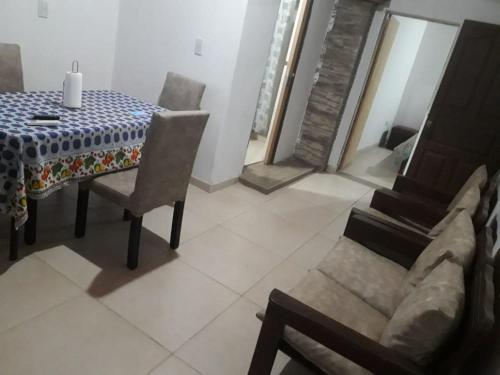 a dining room with a table and chairs in a room at León Apart -un dormitorio- in Corrientes