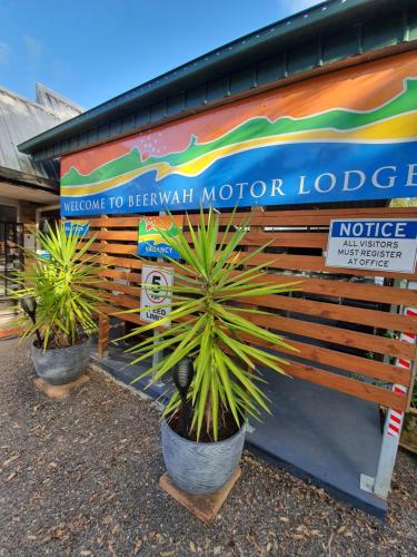 a row of potted plants on a bench in front of a building at Beerwah Motor Lodge in Beerwah