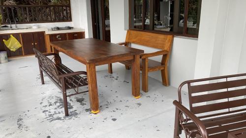 a wooden table and two chairs in a kitchen at Kairos Villa in Seremban
