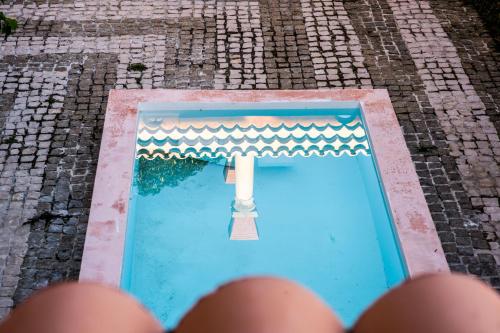 a person is taking a picture of a swimming pool at Villa Yrondi in Bora Bora