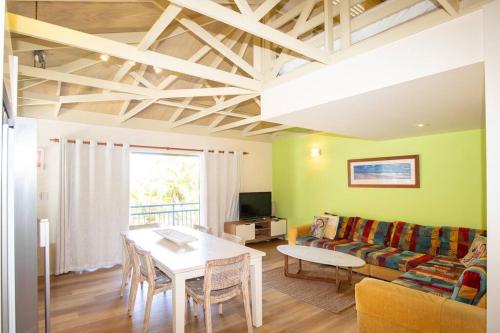 a living room with a table and a couch at BEACHBREAK - 100m to beach - sleeps 6 in Point Lookout