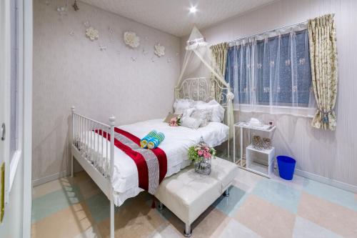 a bedroom with a white bed with a canopy at Diamond Moon Palace Takadanobaba,2 stops to Shinjuku in Tokyo