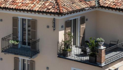 a building with two balconies with plants on them at CIVIICO in Barolo