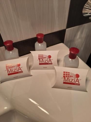 two bottles of nikka on top of a bathroom sink at Hotel Mizia in Targovishte