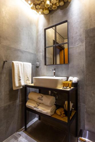 a bathroom with a sink and a mirror and towels at Villa Sokol in Borovets