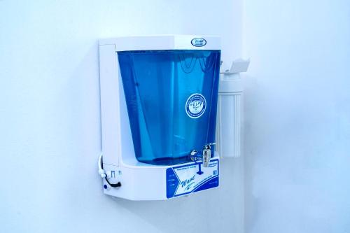 a close up of a blue towel dispenser on a wall at THEKKUMPURAM RESIDENCY in Kondotti