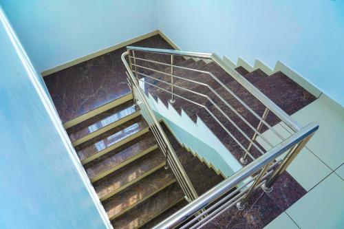 a set of stairs with a metal railing at THEKKUMPURAM RESIDENCY in Kondotti