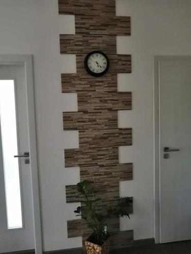 a wall with a clock on a brick wall at Ubytování U Špačků Pálava in Novosedly