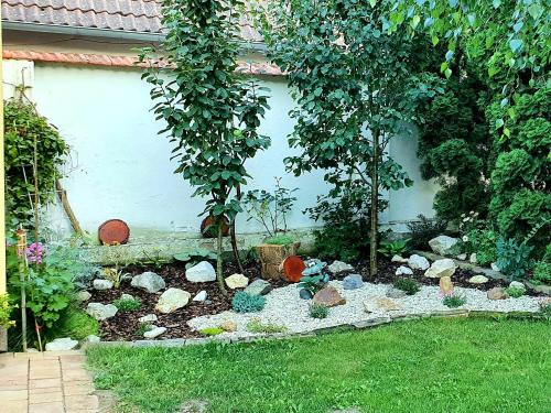 a garden with rocks and trees in a yard at Ubytování U Špačků Pálava in Novosedly