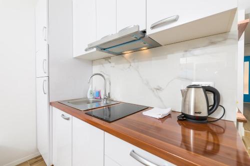 a kitchen with a sink and a coffee maker on a counter at Stella Mare Eco Boutique House in Zavala