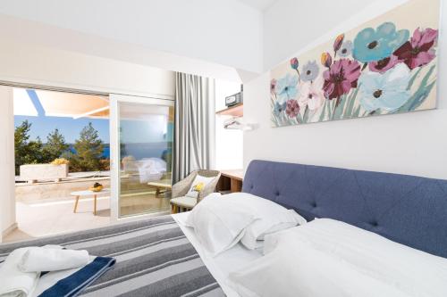 a bedroom with a blue couch and a living room at Stella Mare Eco Boutique House in Zavala