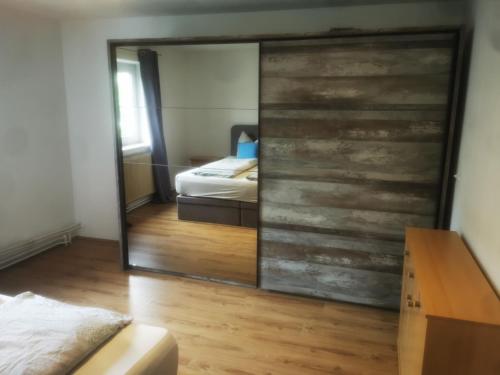 a mirror in a room with a bed and a bedroom at Ferienwohnung Solebad in Gmünd