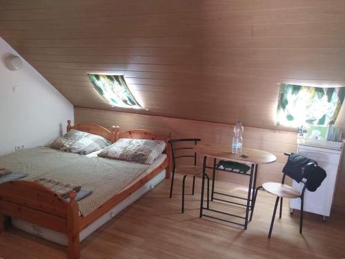 A bed or beds in a room at Balaton Sunset apartman