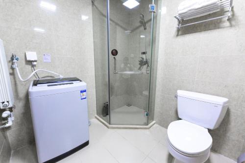 a bathroom with a shower and a toilet and a sink at Gubei Water Town Landscape Villa in Miyun