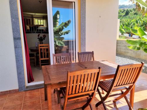 a wooden dining table and chairs in a room at Arco da Calheta Villa in Arco da Calheta